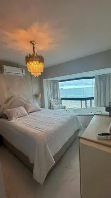 Uma cama ou camas num quarto em Apartamento Frente Mar Itapema