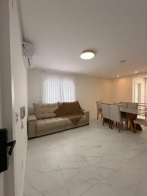 Uma área de estar em Beach House - Cobertura