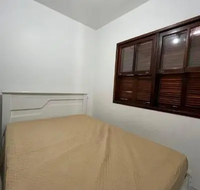 Uma cama ou camas num quarto em Casa de três dormitórios na praia de Palmas