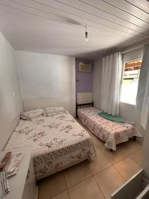 Uma cama ou camas num quarto em Itapema Verão