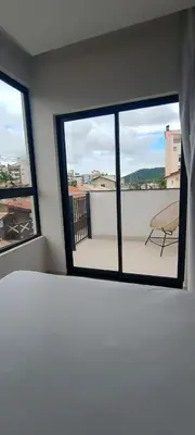 Uma cama ou camas num quarto em Praias de Bombinhas Residencial
