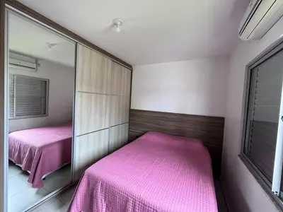 Uma cama ou camas num quarto em casa de Praia Palmas do Arvoredo
