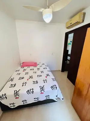 Uma cama ou camas num quarto em apartamento Alamandas praia de Palmas