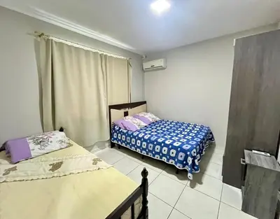 Uma cama ou camas num quarto em Casa Ampla 100m da Praia - Até 08 pessoas