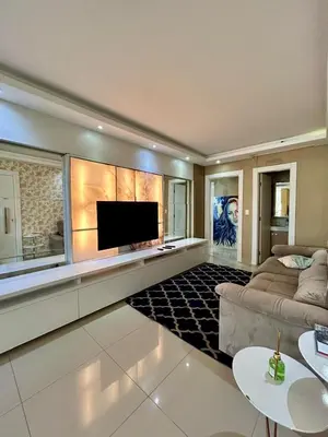 Uma televisão e/ou sistema de entretenimento em Apartamento luxuoso Itapema