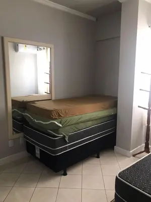 Uma cama ou camas num quarto em Apartamento Centro Meia Praia
