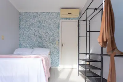 Uma cama ou camas num quarto em Praia, Churrasqueira e Hard Rock em Porto Belo