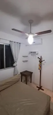 Uma cama ou camas num quarto em Na quadra do mar - apartamento com 3 dormitórios