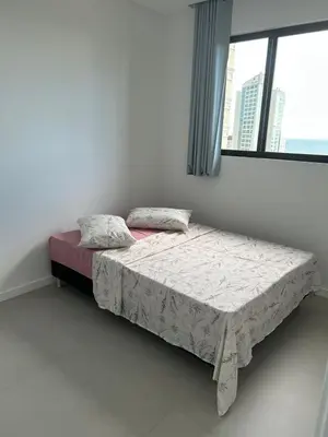 Uma cama ou camas num quarto em Apartamento Novo Proximo ao Mar Experiencia Incrivel