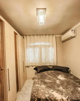 Uma cama ou camas num quarto em Casa aconchegante em Itapema com piscina