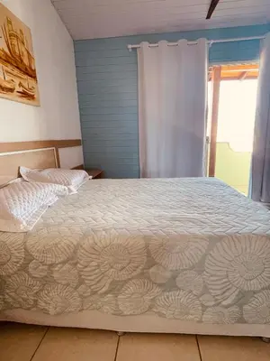 Uma cama ou camas num quarto em Vista Mar Praia da Lagoinha - Residencial Pé na Areia