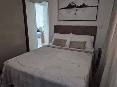 Uma cama ou camas num quarto em Vista mar lateral