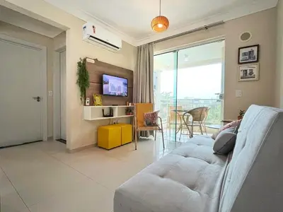 Uma televisão e/ou sistema de entretenimento em Apto ideal p Família, Piscina Térmica 350m Praia