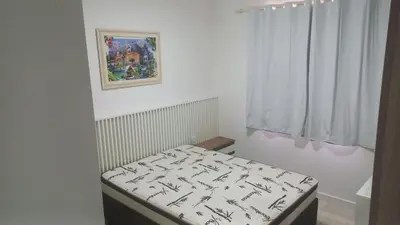 Uma cama ou camas num quarto em APARTAMENTO Pé NA AREIA ITAPEMA