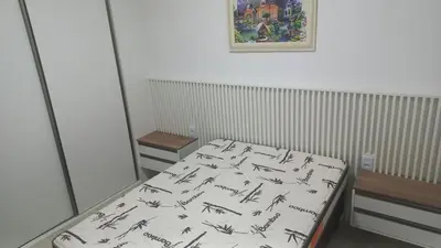 Uma cama ou camas num quarto em APARTAMENTO Pé NA AREIA ITAPEMA