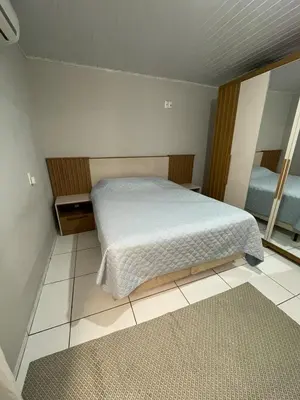 Uma cama ou camas num quarto em Casa com piscina em Bombinhas - SC