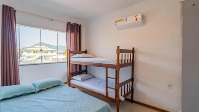 Uma cama ou camas num quarto em Sobrado B 3 quartos Canto Grande