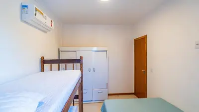 Uma cama ou camas num quarto em Sobrado B 3 quartos Canto Grande