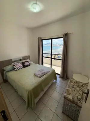 Uma cama ou camas num quarto em Cobertura frente mar em Itapema