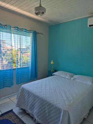 Uma cama ou camas num quarto em CASA Regina