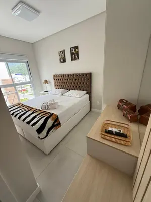 Uma cama ou camas num quarto em Apartamento Carlos Daniela