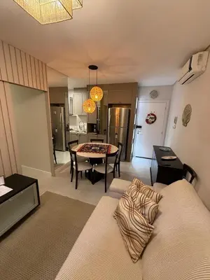 Uma área de estar em Apartamento Carlos Daniela