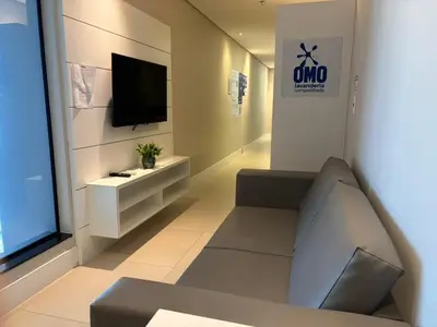 Uma televisão e/ou sistema de entretenimento em Vista Mar, Suíte Moderna para até 3 Pessoas