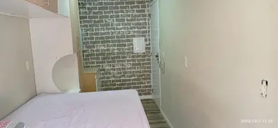 Uma cama ou camas num quarto em Itapema predio rua 292