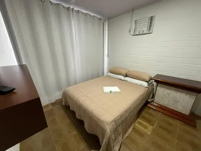 Uma cama ou camas num quarto em Chalé 01 centro de itapema 150m do mar