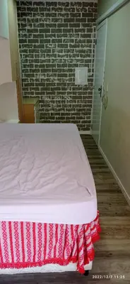 Uma cama ou camas num quarto em Itapema predio
