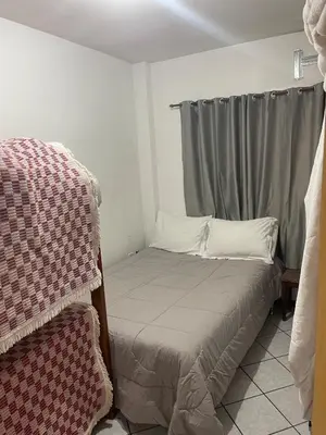 Uma cama ou camas num quarto em Apartamento Meia Praia verão 2026