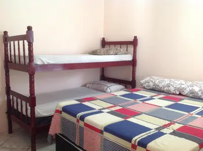 Uma cama ou camas num quarto em Casa em Bombinhas zimbros