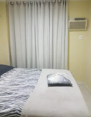 Uma cama ou camas num quarto em Residencial Villa Toscana - Apartamento Bombas 100M da Praia