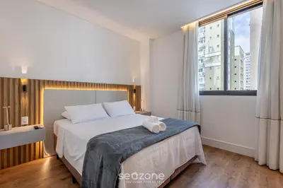 Uma cama ou camas num quarto em Aptos a apenas passos da Praia em Itapema - EAHs