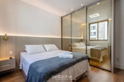 Uma cama ou camas num quarto em Aptos a apenas passos da Praia em Itapema - EAHs