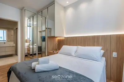 Uma cama ou camas num quarto em Aptos a apenas passos da Praia em Itapema - EAHs