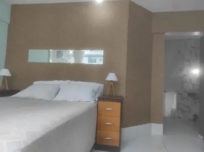 Uma cama ou camas num quarto em Pé na Areia com Garagem GRÁTIS 3 Quartos na Orla de Balneário Camboriú