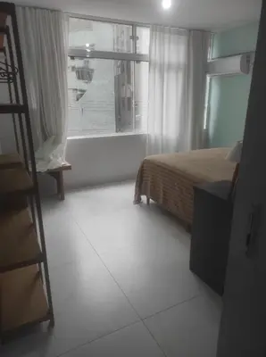 Uma cama ou camas num quarto em Pé na Areia com Garagem GRÁTIS 3 Quartos na Orla de Balneário Camboriú