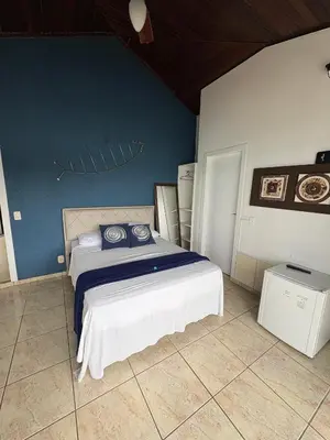 Uma cama ou camas num quarto em Caixa d aço residence