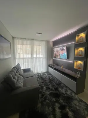 Uma televisão e/ou sistema de entretenimento em Edifício Arpoador Praia de Palmas - 250m da praia