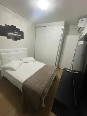 Uma cama ou camas num quarto em Edifício Arpoador Praia de Palmas - 250m da praia