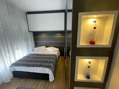 Uma cama ou camas num quarto em Edifício Arpoador Praia de Palmas - 250m da praia