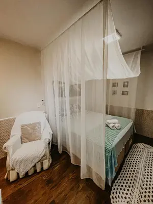 Uma cama ou camas num quarto em Pousada Canto do Pescador