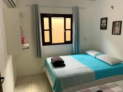Uma cama ou camas num quarto em Casa Bombinhas
