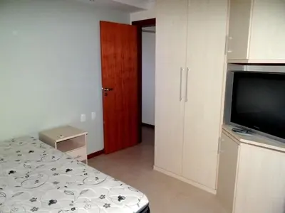 Uma cama ou camas num quarto em Novo Lar 1 Bombinhas (Eliseos)