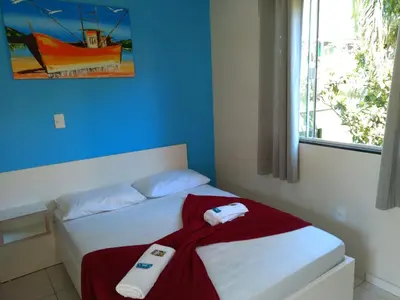 Uma cama ou camas num quarto em Pousada Camping Bombinhas