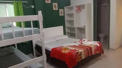 Uma cama ou camas num quarto em Pousada Camping Bombinhas