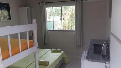 Uma cama ou camas num quarto em Pousada Camping Bombinhas