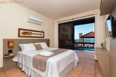 Uma cama ou camas num quarto em Pousada Kia Ora Bombinhas
