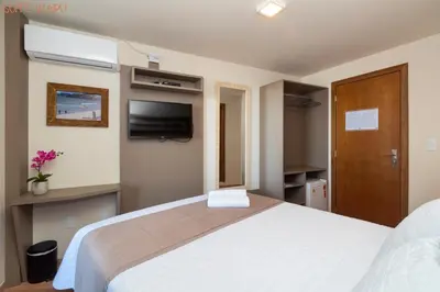 Uma cama ou camas num quarto em Pousada Kia Ora Bombinhas